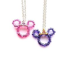 two necklaces with mickey and minnie mouse heads on them, one is pink and the other is blue