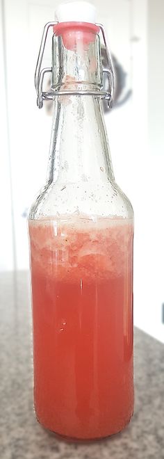 a bottle filled with liquid sitting on top of a counter