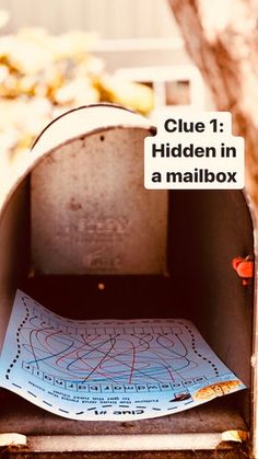 an open mailbox with a piece of paper stuck to the outside in front of it that says clue 1 hidden in a mailbox