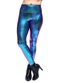 a woman in blue and green mermaid leggings with her hands on her hips