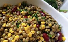 a white bowl filled with corn and vegetables