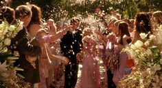 the bride and groom are showered with confetti