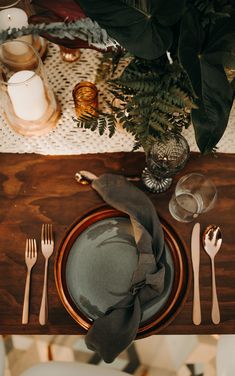 the table is set with silverware and plates