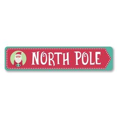 a red and green sign that says north pole with a santa claus face on it