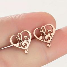 Unique Music Notes And Treble Clef In A Heart Rose Gold Toned Stud Earrings. Perfect For Any Musician Or Music Lover. Also Available In Gold Toned, Silver Toned And Black. Rose Gold Metal Heart Earrings For Valentine's Day, Treble Clef Heart, Large Gold Earrings, Heart Rose, Initial Earrings, Western Earrings, Treble Clef, Chanel Earrings, Love Music