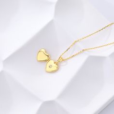 Our new Heart Mini Locket Necklace is a dainty way to celebrate the love in your life! This tiny, yet meaningful necklace opens with space inside for two initials - perfect for you and your partner as a reminder that it all started with you falling in love. Or, engrave any two initials that are special to you! locket can be engraved inside with one initial per side (uppercase only) hangs on adjustable cable chain locket measures 12 x 10mm gold vermeil and sterling silver lockets have a cubic zir Dainty Locket Necklace For Valentine's Day Anniversary, Dainty Heart Locket Necklace For Anniversary Gift, Dainty Locket Charm Necklace For Anniversary, Valentine's Day Necklace With Initial Pendant Locket, Valentine's Day Necklaces With Initial Pendant Locket, Minimalist Locket Charm Necklace For Gifts, Mother's Day Double Heart Charm Necklace With Adjustable Chain, Dainty Heart Locket Necklace For Anniversary, Dainty Pendant Locket Necklace For Anniversary