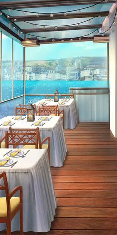 a dining area with tables and chairs overlooking the water