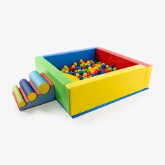 a toy box filled with lots of colorful balls