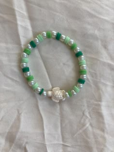 Cute green and white beaded bracelet with turtle charm. These are high quality handmade bracelets. They are made with an very stretchy and strong elastic string so will fit lots of sizes. They are around 6.75 inches. Please note that each braclet will have a very similar beading pattern but not exactly identical. Mint Green Clay Bead Bracelet, Cute Clay Bead Bracelet Ideas Green, Green Clay Bead Bracelet Ideas, Green Bracelet Ideas, Bracelet Patterns Clay Beads, Cute Clay Bead Bracelet Ideas, Pearl Bead Patterns, Cute Bracelets Ideas