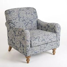 a blue and white patterned chair against a white background with an ornate pattern on it