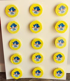 several yellow frisbees with sonic the hedgehog logos are arranged on a white board