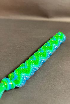 a toothbrush with green and blue swirls on it