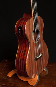 an acoustic guitar sitting on top of a wooden table