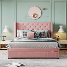 a bed with pink headboard and pillows in a green room next to two lamps