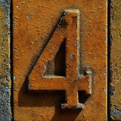 the number four is made from rusted metal