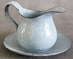 a white pitcher sitting on top of a saucer