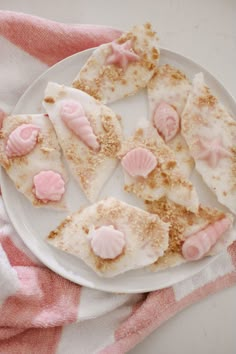 some kind of desert on a white plate with pink icing and sprinkles