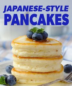 a stack of pancakes with blueberries and syrup on top