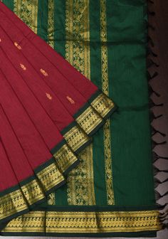 Illuminate your wardrobe with this Maroon Cotton Silk Saree. The charming hue is elegantly paired with intricate zari borders and delicate buttas, offering a rich and sophisticated look. Crafted for comfort and ease of maintenance, this saree ensures a graceful look! It is ready to wear with falls and  pico. An unstitched blouse fabric is included. Note: This is a completely handmade product made of natural yarns. There may be slight inconsistencies in the weave or texture that are characteristi Elegant Traditional Wear With Border For Eid, Elegant Art Silk Traditional Wear With Border, Elegant Festive Traditional Wear With Border, Traditional Wear For Diwali With Border, Elegant Traditional Wear With Border For Transitional Season, Classic Traditional Wear With Traditional Drape For Festive Occasions, Elegant Red Traditional Wear With Border, Elegant Traditional Wear With Border For Ceremonies, Classic Festive Traditional Wear With Traditional Drape