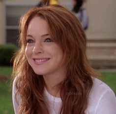 a close up of a person sitting on a bench with grass in front of them