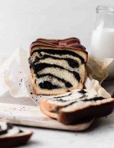 a slice of zebra print bread on a cutting board next to a glass of milk