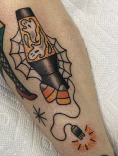 a person with a tattoo on their leg that has a pencil and spider web in it