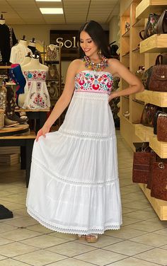 This Beautiful Strapless Dress boasts a Traditional Mexican floral design combined with a modern style dress. The corrugated skirt combined with the strapless embroidered top makes it fun and flirty. It's made out of fine Mexican corrugated cotton and has elastic on the back for a tighter fit. It has lace details throughout. This dress is handmade and completely hand embroidered by Mexican Artisans in Puebla, Mexico. More available dresses here: https://www.etsy.com/es/shop/SoleiEthnic?ref=selle Mexican Wedding Dress Guest, Festival Embroidered Maxi Dress With Embroidered Hem, Festival Embroidered Hem Maxi Dress, Festival Maxi Embroidered Dress With Embroidered Hem, Bohemian Sleeveless Dress With Embroidered Hem, Bohemian Sleeveless Embroidered Dress, Festival Maxi Length Embroidered Dress, Fitted Embroidered Bohemian Boho Dress, White Sleeveless Bohemian Embroidered Dress