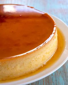 a cheesecake covered in caramel sauce on a white plate