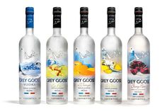 three bottles of grey goose vodka are lined up in front of each other on a white background