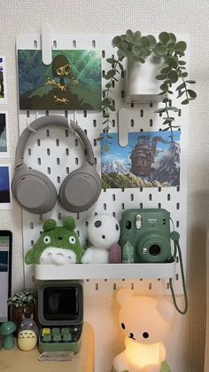 there is a shelf with pictures and headphones on it