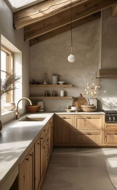 a kitchen with lots of counter space and wooden cabinetry, along with a skylight