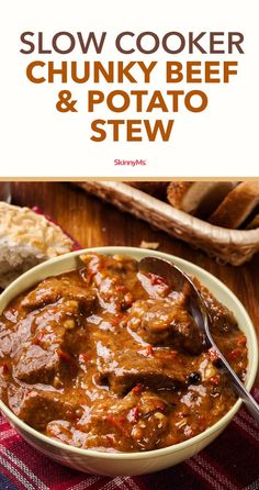 slow cooker chunky beef and potato stew in a bowl with bread on the side