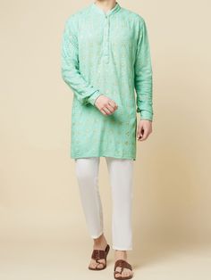 This Mint Green Lucknowi Embroidered kurta will instantly give an elegant look. Made from polyester cotton fabric, this 2 piece kurta set features a mint green lucknowi kurta, front buttons fastening, designer cuff buttons, and a mandarin collar. This mint green kurta has beautiful sequins Jaal thread embroidery work all over. It is paired with white churidar pants. An ideal outfit for traditional & special events.

Size Chart For Men





	
	
					Men's Size Chart
		

		
		
						
				Size Char Casual Chikankari Embroidery Kurta For Festive Occasions, Spring Long Sleeve Self Design Kurta, Unstitched Pista Green Kurta For Spring, Pista Green Kurta With Resham Embroidery For Spring, Pista Green Resham Embroidered Kurta For Spring, Casual Kurta With Dabka Work For Eid, Spring Pista Green Kurta With Resham Embroidery, Festive Pista Green Cotton Kurta, Traditional Pista Green Kurta For Spring