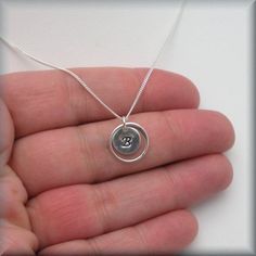 "A lovely sterling frame encircles a small initial charm. Personalized and simple - the perfect neckace to stand alone or layer, as you wish. Each initial is handstamped and then slightly darkened to stand out on the sterling disc. The pendant measures slightly larger than 1/4\" round (9 mm). Sterling silver curb chain. All other components are sterling silver. Jewelry is packaged in a cotton lined box for gift-giving. See more Bonny Jewelry at http://bonnyjewelry.etsy.com If this is a gift and Simple Bridesmaid Gift, Monogram Jewelry, Personalized Monogram, Necklace Personalized, Initial Charm, Curb Chain, Bridesmaid Gift, Name Necklace, 925 Sterling Silver Ring