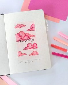 an open notebook with pink clouds and the word memory written in cursive writing