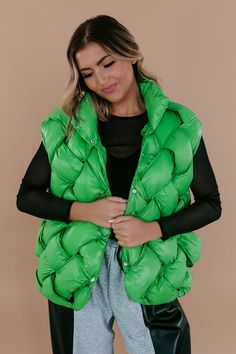 Introducing our Button Woven Puffer Vest in Green – a cozy and stylish layer for your wardrobe. With a quilted design and a convenient button-up front, this vest adds a pop of color to your look. Snap button closure Criss-cross detailing creating peek holes Not lined 100% nylon Imported Model Specs: Emily is wearing a size small in the photo.How will this item fit you? Check out our MODEL SPECS (Typical Sizing - Karli: S-Size 5/26 - 5ft 2in, Emily: S-Size 3/25 - 5ft 5in, Syd: L/XL- Size 15/ - 5ft 8in)﻿Need help with sizing? No problem! Join our VIP group on Facebook, Everyday Chic Boutique VIP Insiders to chat directly with our team and other customers just like you.Packaged with love and shipped from our warehouse in Wilmington, Ohio Green Vest Outerwear For Fall, Green Winter Vest With Buttons, Winter Layering Vest With Button Closure, Trendy Winter Vest With Button Closure, Trendy Winter Vest With Buttons, Green Layering Vest Outerwear, Winter Sleeveless Vest With Snap Buttons, Green Winter Vest For Layering, Green Vest Outerwear For Layering