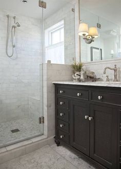 a bathroom with two sinks and a walk in shower