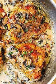 chicken with mushroom sauce in a pan on a wooden table