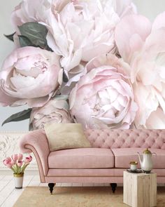 a living room with pink furniture and large flowers on the wall behind it, in front of a white background