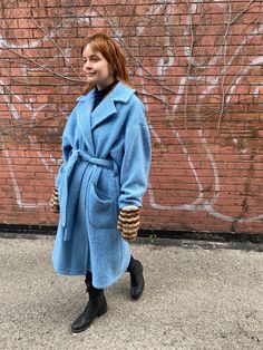 "This coat is handmade from a preowned mid-century wool blanket which deserved a second life. It has signs of use, no stains.  The coat has a classic double notched lapel, drop shoulders, long and straight. It closes with a belt. It has smiley welt patch pockets and no lining. The sleeve cuffs are cinched with kilt pins. The material is 100% wool, the blanket is thick and fuzzy. Width (pit 2 pit with 4\" overlap): 48\" Back length (nape 2 hem): 44\" Sleeve (nape 2 cuff): 31\" Belt length: 72\" Model measurements: bust 35\", waist 28.5\", hip 36\", 5'8 Dry clean/spot clean. One of a kind. any further questions please don't hesitate to contact me!" Blue Wool Coat With Lapel Collar And Pockets, Blue Wool Coat With Lapel Collar, Blue Wool Outerwear For Cold Weather, Blue Single-breasted Wool Coat For Spring, Blue Wool Outerwear For Winter, Blue Wool Coat With Pockets For Work, Blue Shawl Collar Outerwear For Work, Blue Wool Outerwear With Pockets, Blue Shawl Collar Outerwear For Fall