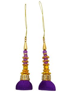 pair of purple tassels with gold trimming and beads on the ends, hanging from