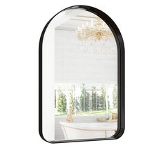 an arched mirror with a chandelier hanging from it