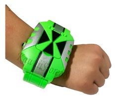 a green wrist watch on someone's arm with black and silver details in the middle