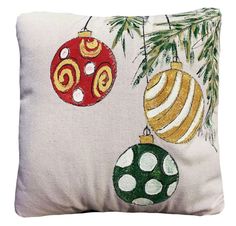 a pillow with ornaments on it sitting on top of a wooden table next to a metal wall