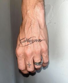 a man's hand with the word dream tattooed on it