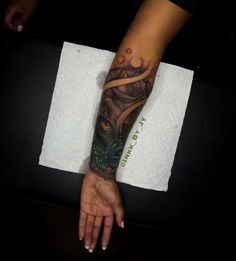 a woman's arm with a tattoo on it and an owl in the middle