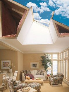 a living room filled with furniture and a skylight in the middle of it's ceiling