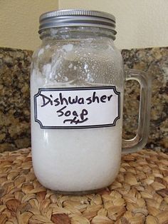 a glass jar filled with white liquid sitting on top of a counter