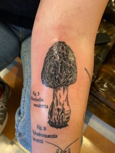 a tattoo with an image of a mushroom on it's arm and the words underneath it