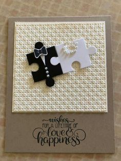 a card with two pieces of white and black puzzles on it, the words wishes for a life time of love's happiness